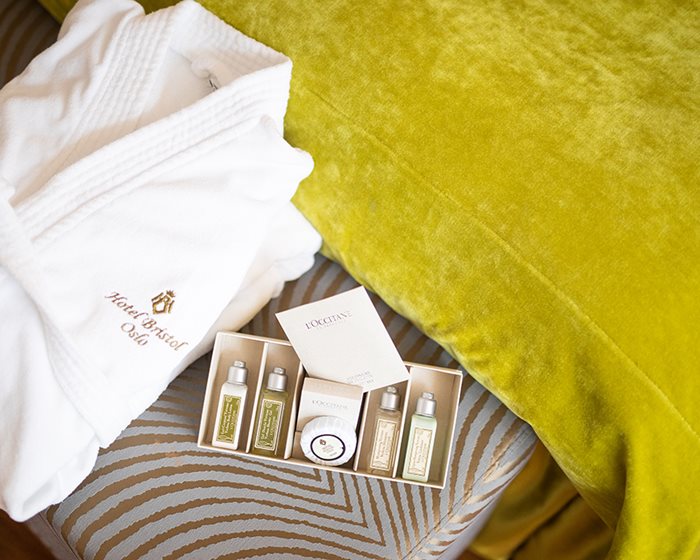 Bathrobe and slippers with adjacent toiletry products